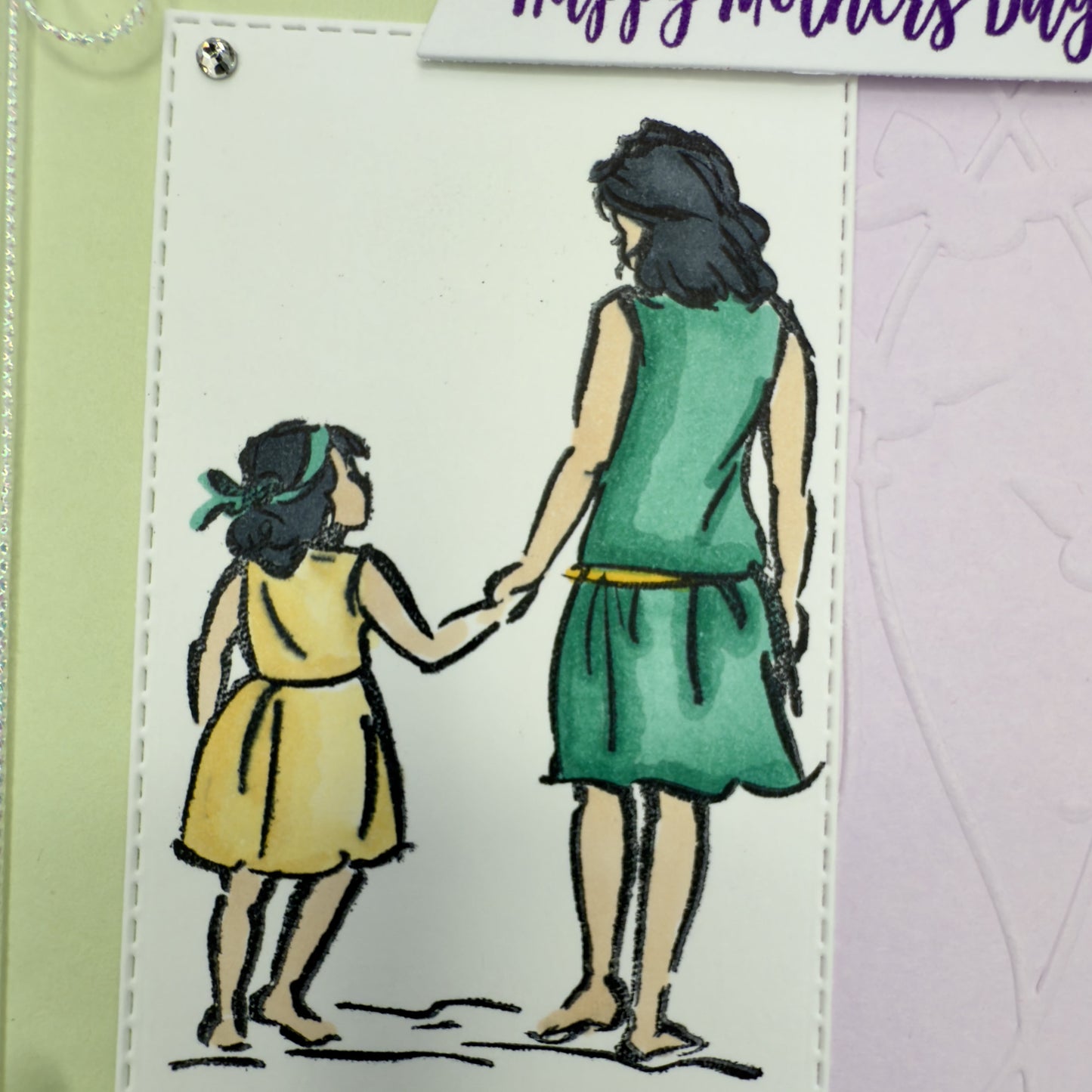 Details of a hand-crafted greeting card in green and lavender hues with the message ‘Happy Mother’s Day,’ shown with its matching envelope — elegant and loving floral design.