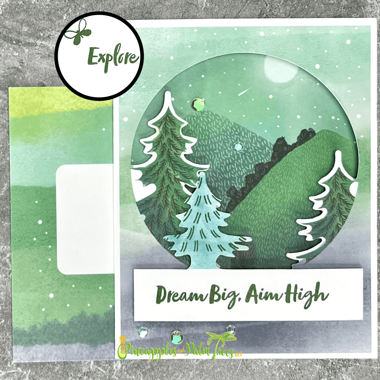 Front of greeting card reading ‘Dream Big, Aim High’ with a stylized mountain design, shown with the included envelope — a handmade encouragement card for achievers.