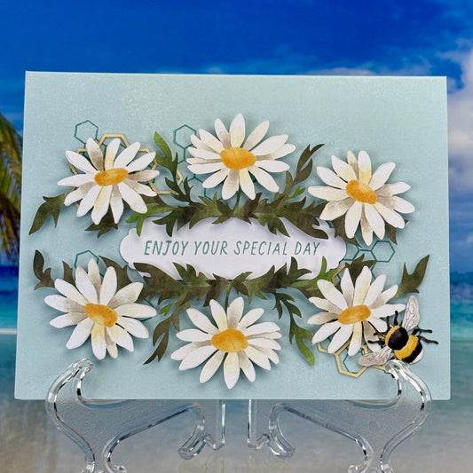 Greeting card with daisies and the message ‘Enjoy Your Special Day’.