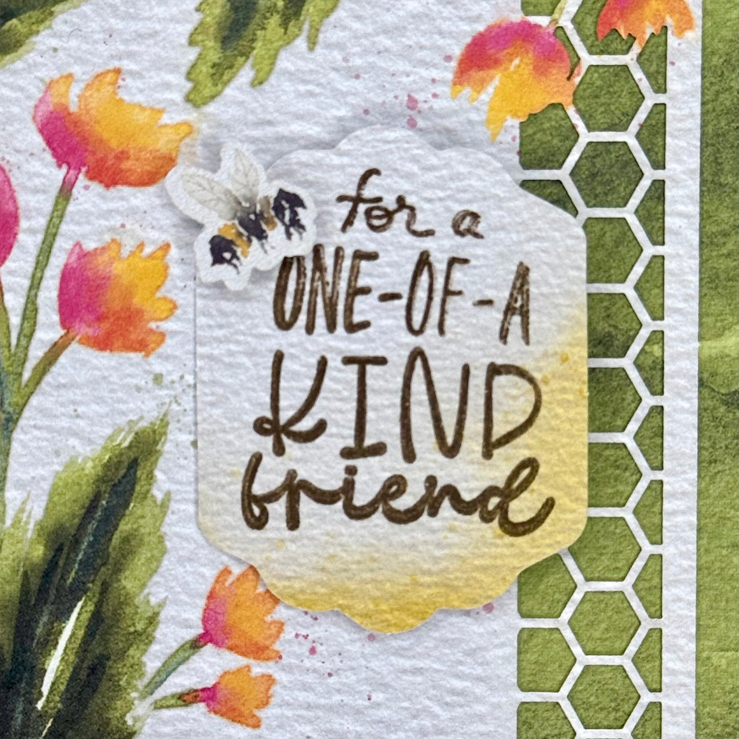 Details of a greeting card with cute bee and flower illustrations and the message “For a one-of-a-kind friend” 