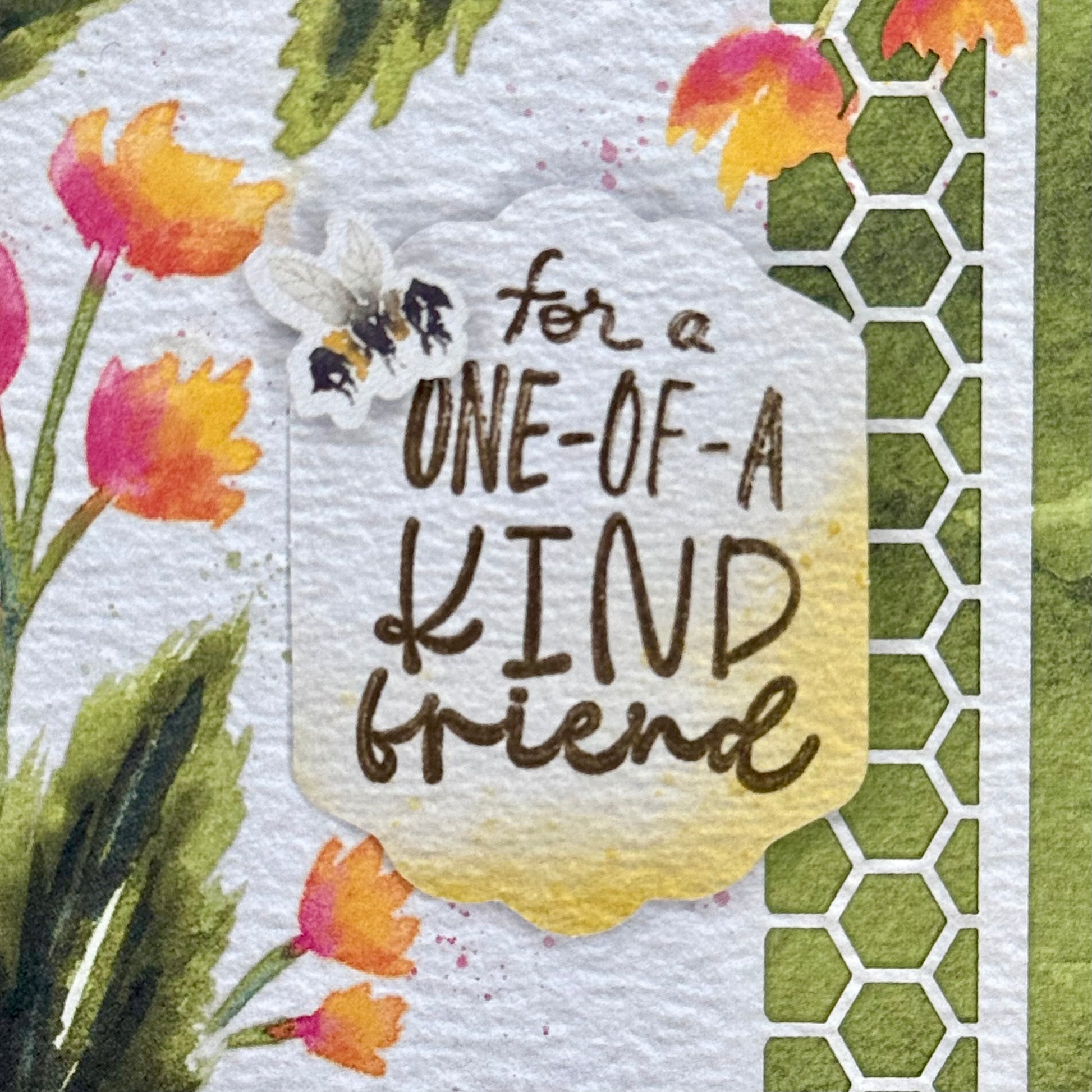 Details of a greeting card with cute bee and flower illustrations and the message “For a one-of-a-kind friend” 