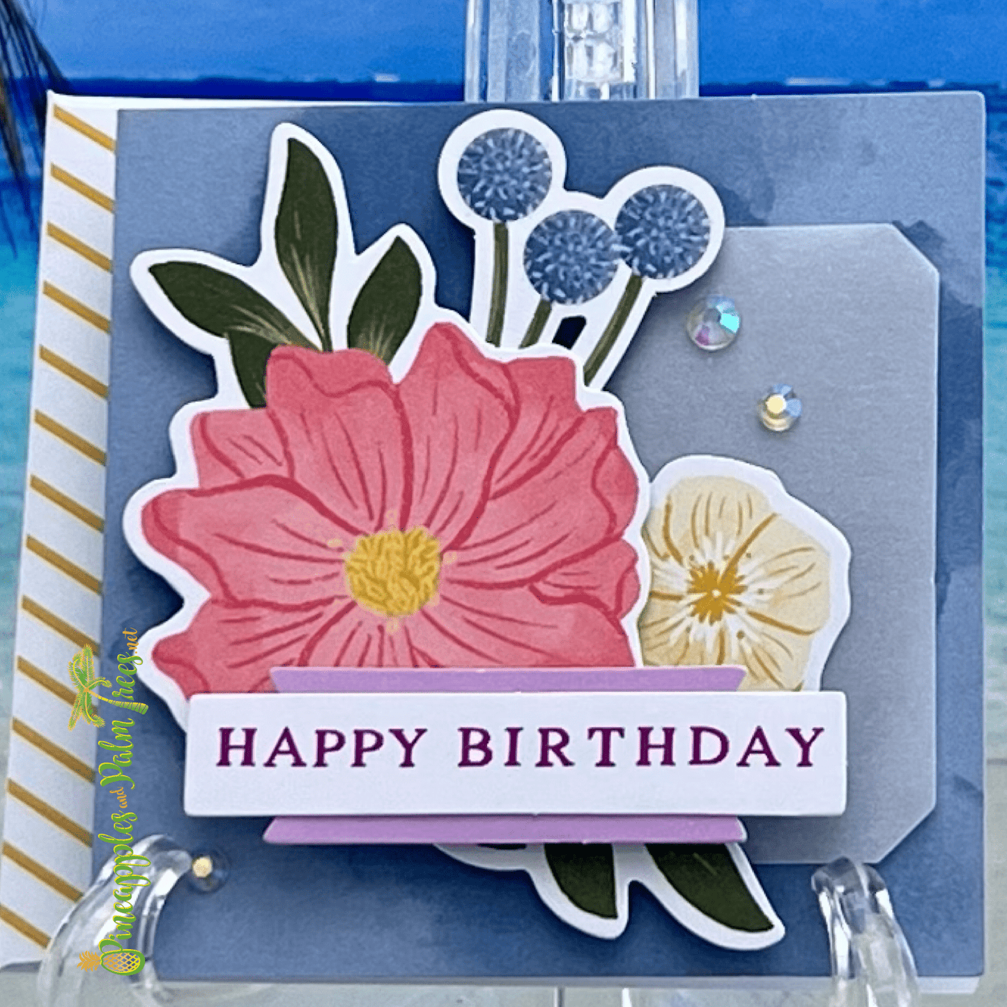 Happy Birthday greeting card featuring three colorful flowers 