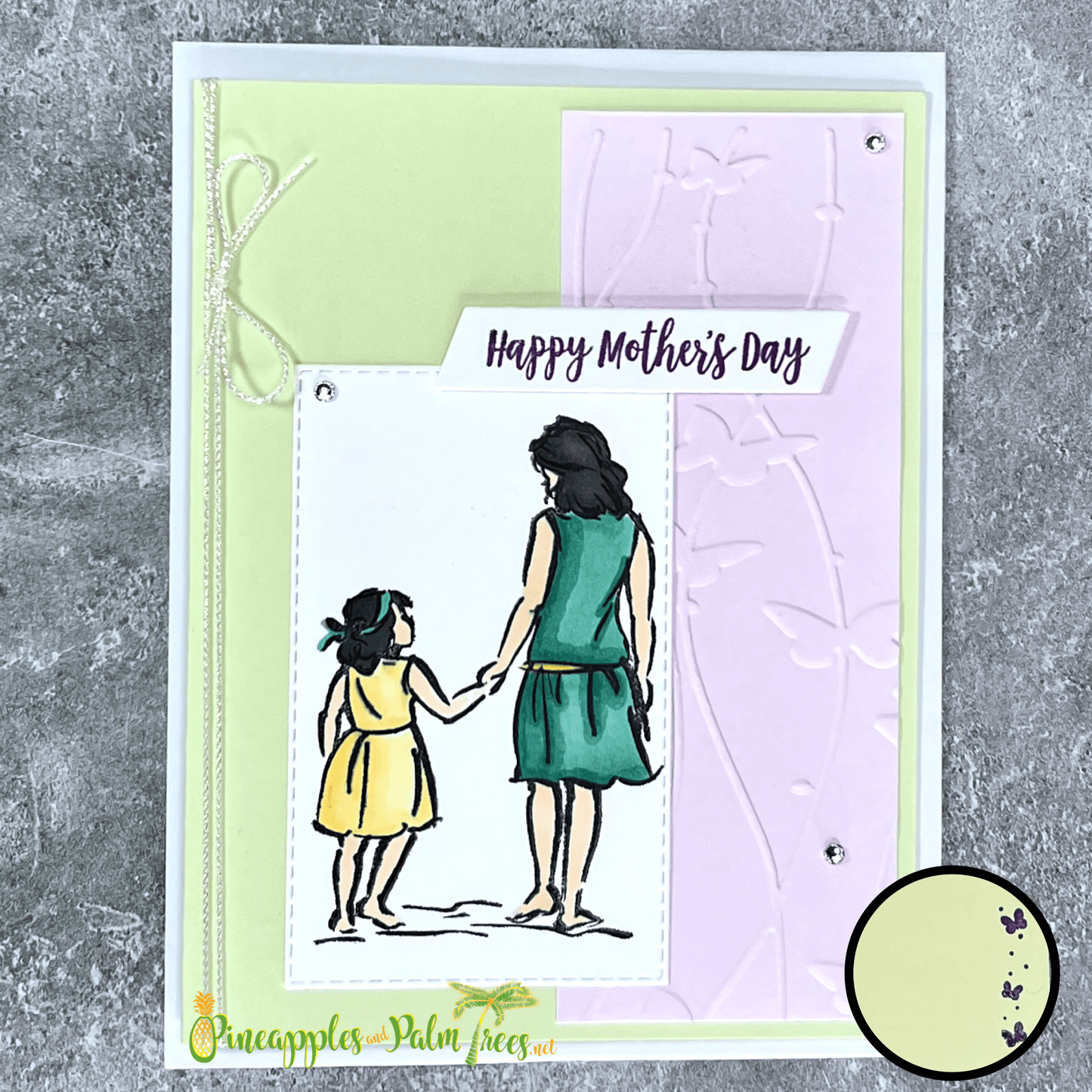 Hand-crafted greeting card in green and lavender hues with the message ‘Happy Mother’s Day,’ shown with its matching envelope — elegant and loving floral design.