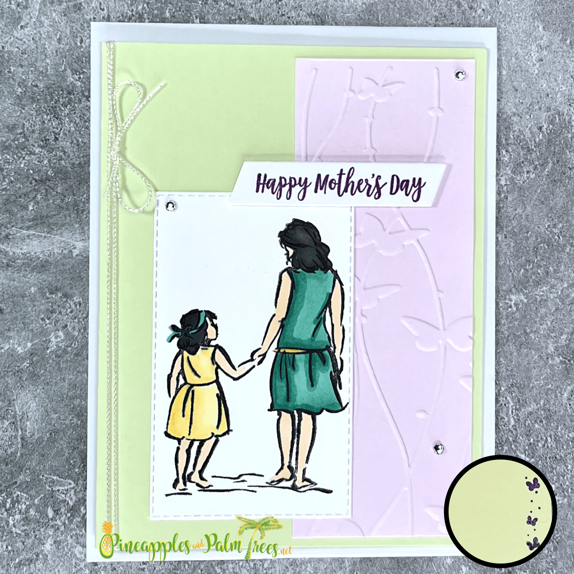 Hand-crafted greeting card in green and lavender hues with the message ‘Happy Mother’s Day,’ shown with its matching envelope — elegant and loving floral design.