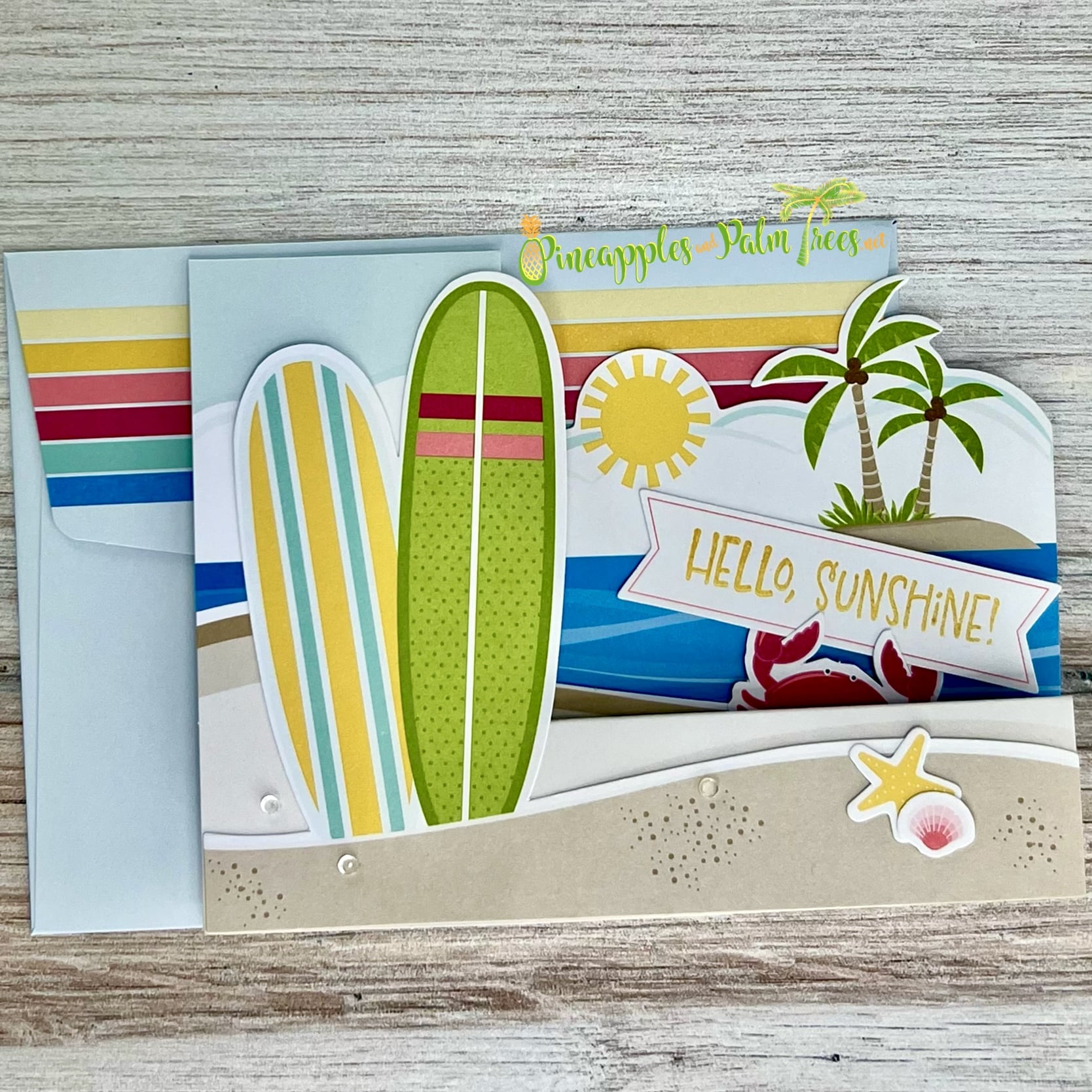 Greeting card with a beach scene illustration and the words ‘Hello Sunshine,’ shown with its matching envelope — handcrafted coastal‑inspired design perfect for sending warm, sunny vibes.