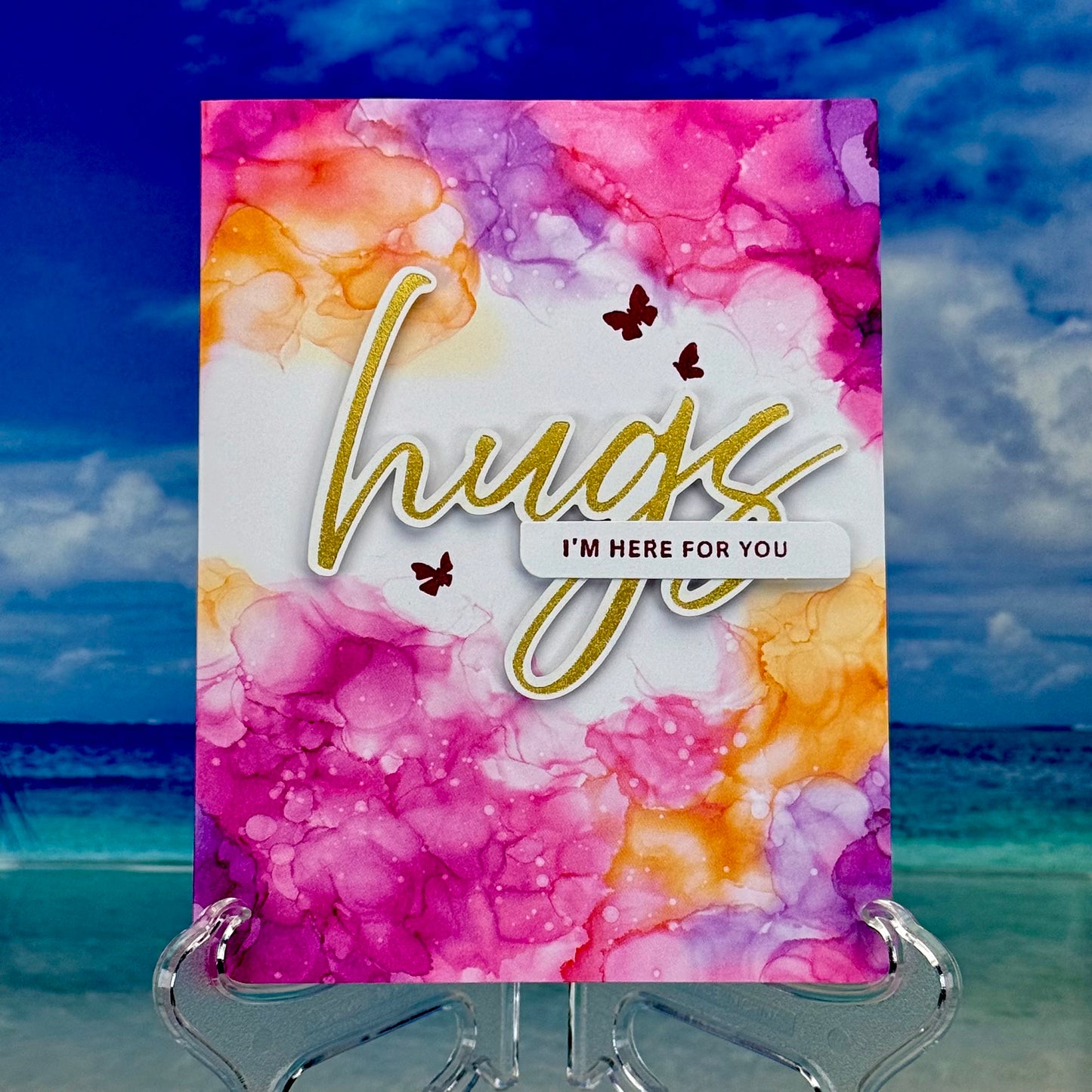 Hand-crafted greeting card front reading ‘hugs, I’m here for you’ with soft watercolor butterflies and coordinating envelope — a comforting design for support and encouragement.