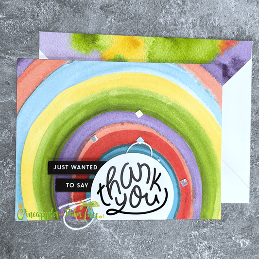 Greeting card reading ‘Just Wanted to Say Thank You’ with cheerful rainbow design, shown with its matching envelope — bright, handmade, and heartfelt.