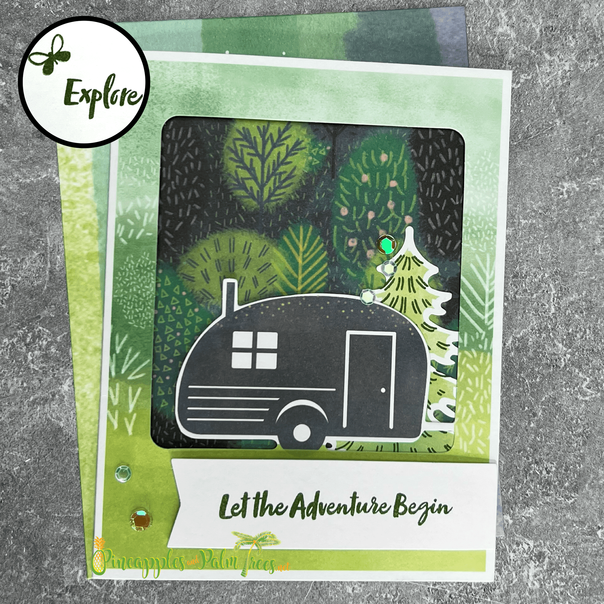 Greeting card with the phrase ‘Let the Adventure Begin’ featuring a vintage trailer illustration, shown with its matching envelope — perfect for new journeys, housewarmings or road-trip gifts.