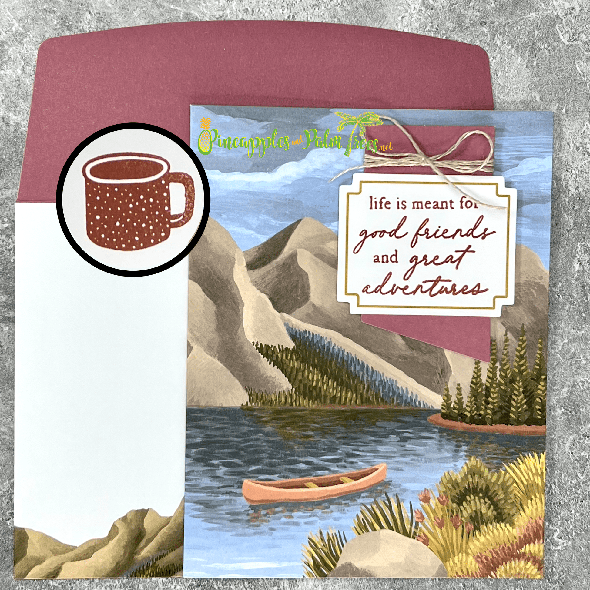 Greeting card with the message ‘Life is meant for good friends and great adventures,’ featuring a lake-and-mountains illustration, shown with its matching envelope — inspirational design perfect for travel lovers and best friends.