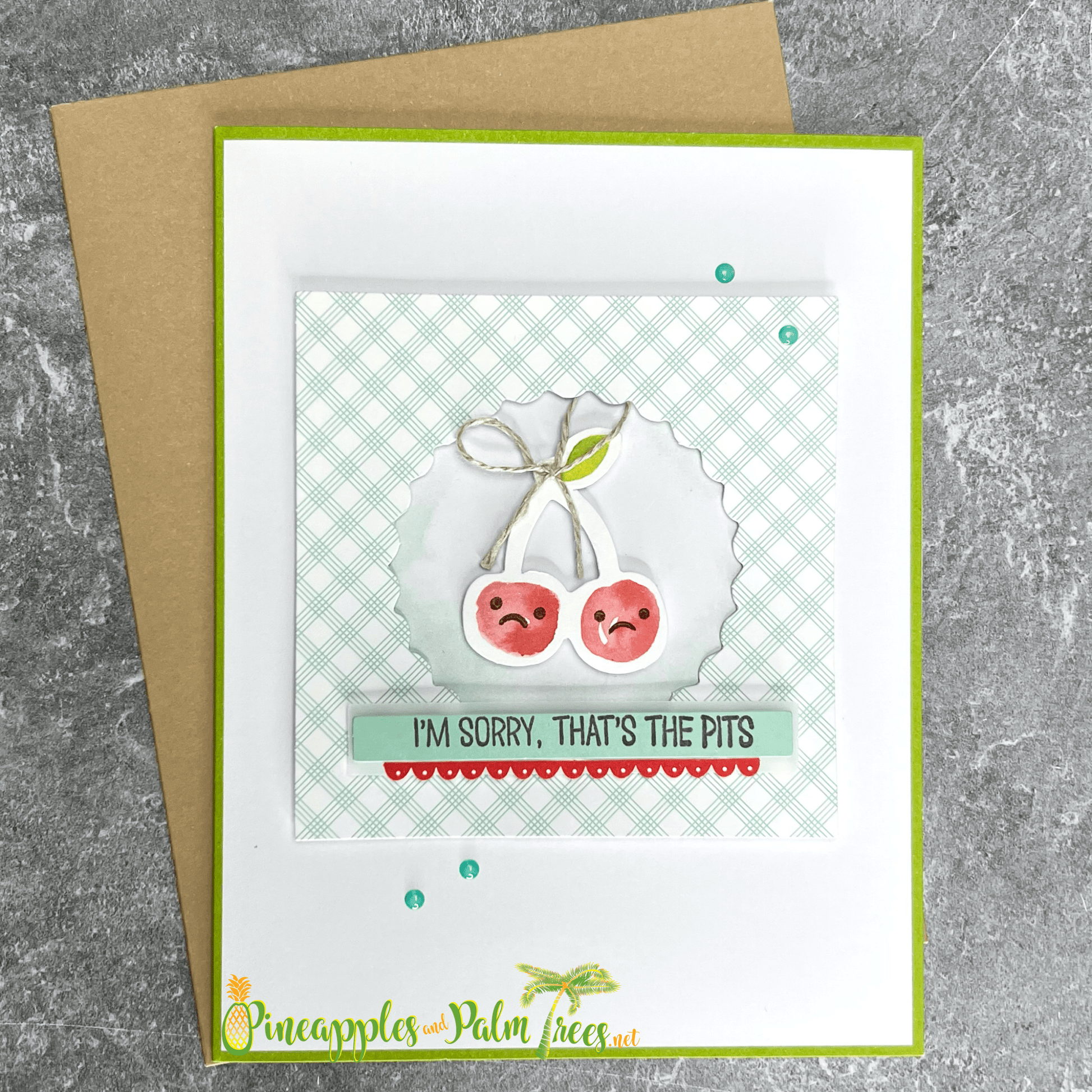 Greeting card with the message ‘I’m Sorry — That’s the Pits’ and cherry illustrations, shown with its matching envelope — a sweet, lighthearted apology card.


