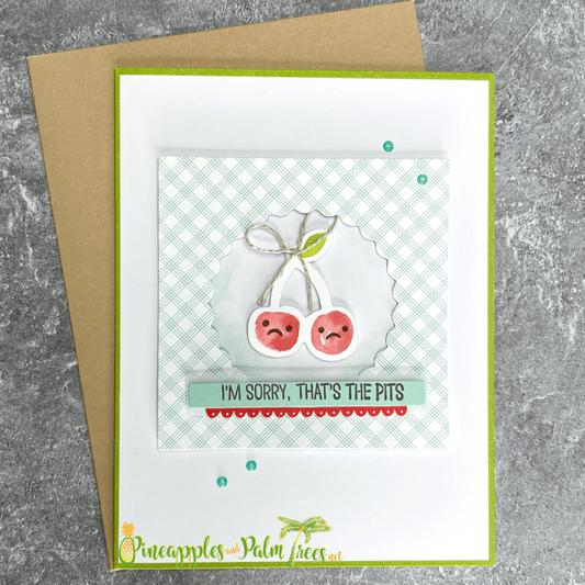 Greeting card with the message ‘I’m Sorry — That’s the Pits’ and cherry illustrations, shown with its matching envelope — a sweet, lighthearted apology card.

