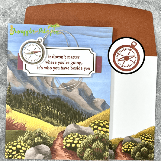 Greeting card with the message ‘It doesn’t matter where you’re going — it’s who you have beside you,’ illustrated with a scenic trail and trees, shown with its matching envelope — heartfelt and nature-inspired design.