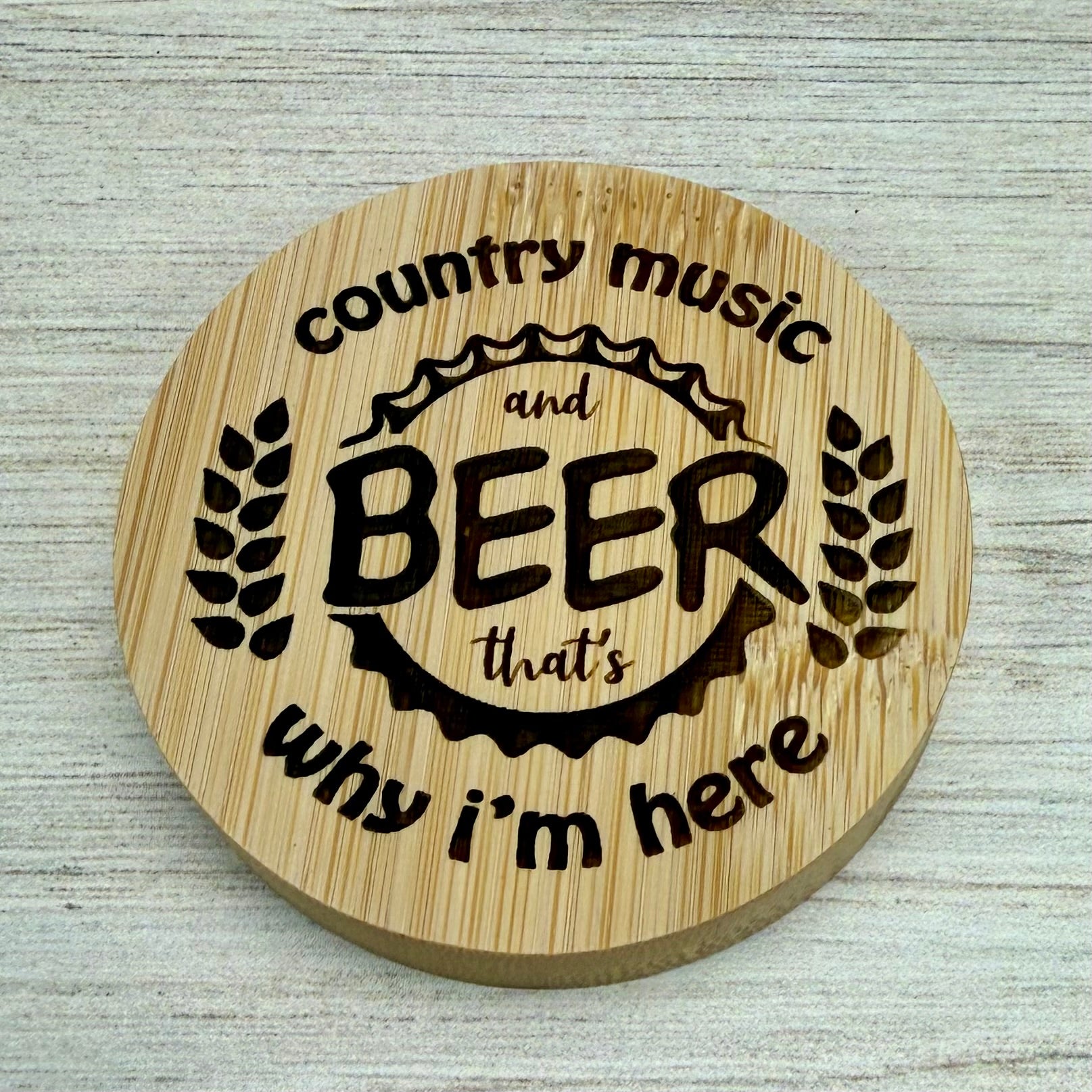 Round laser-engraved bottle opener with “Country Music & Beer, That’s Why I’m Here” design.