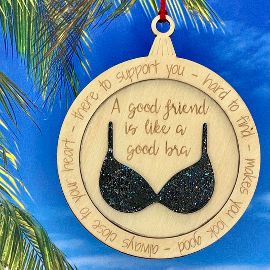 Lasered Christmas ornament with humorous message “A Good Friend Is Like a Good Bra,” perfect for gifting friends.