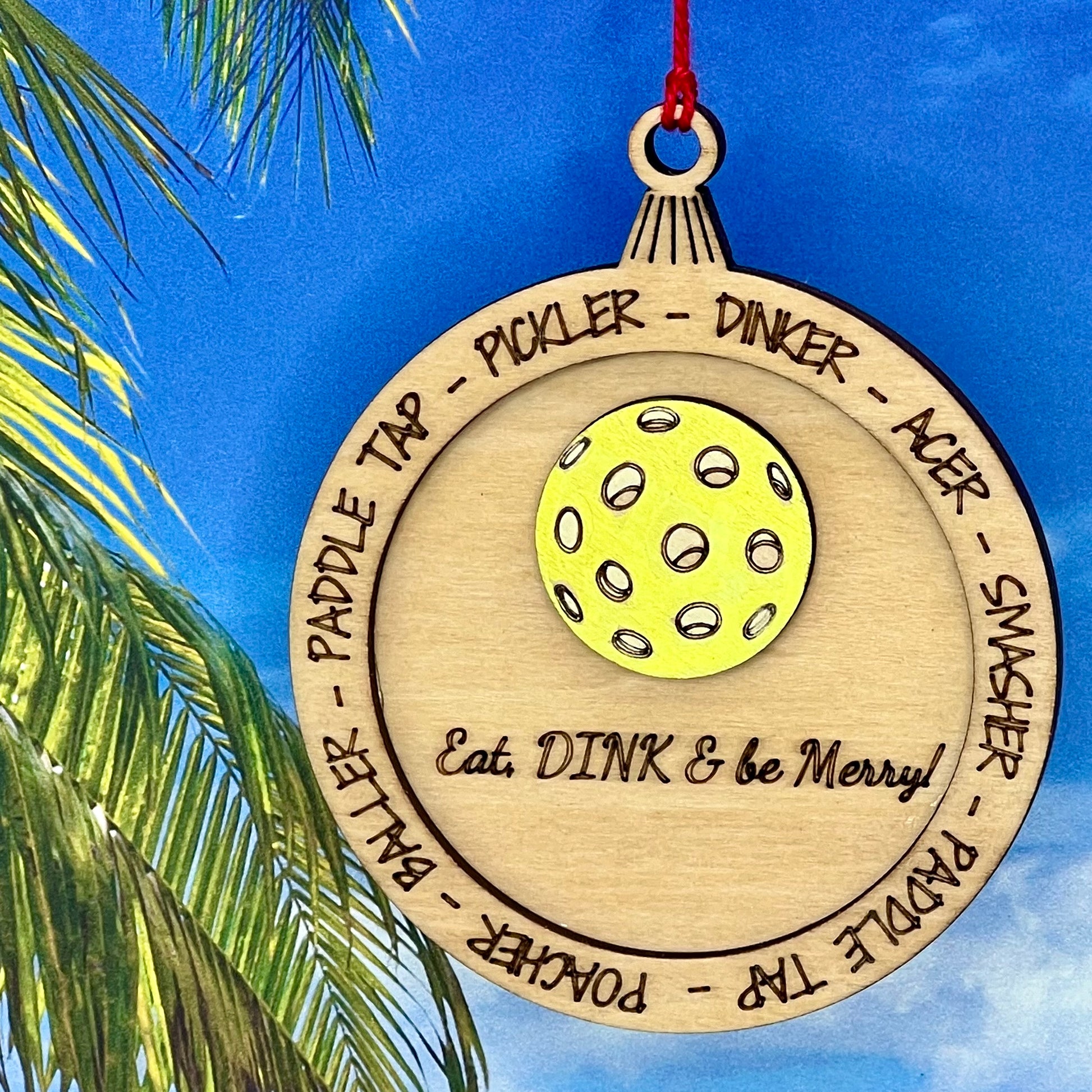 Lasered Christmas ornament with pickleball design, perfect for holiday décor and sports enthusiasts.