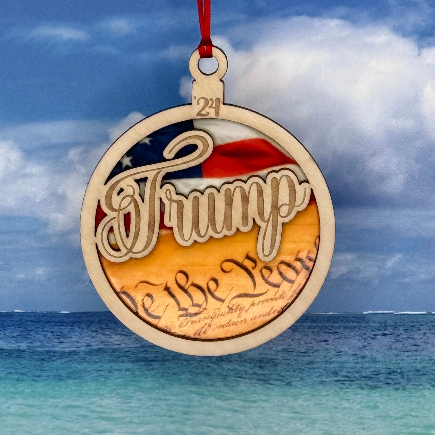 Lasered Christmas ornament featuring Trump design, perfect for holiday décor or novelty gifting.
