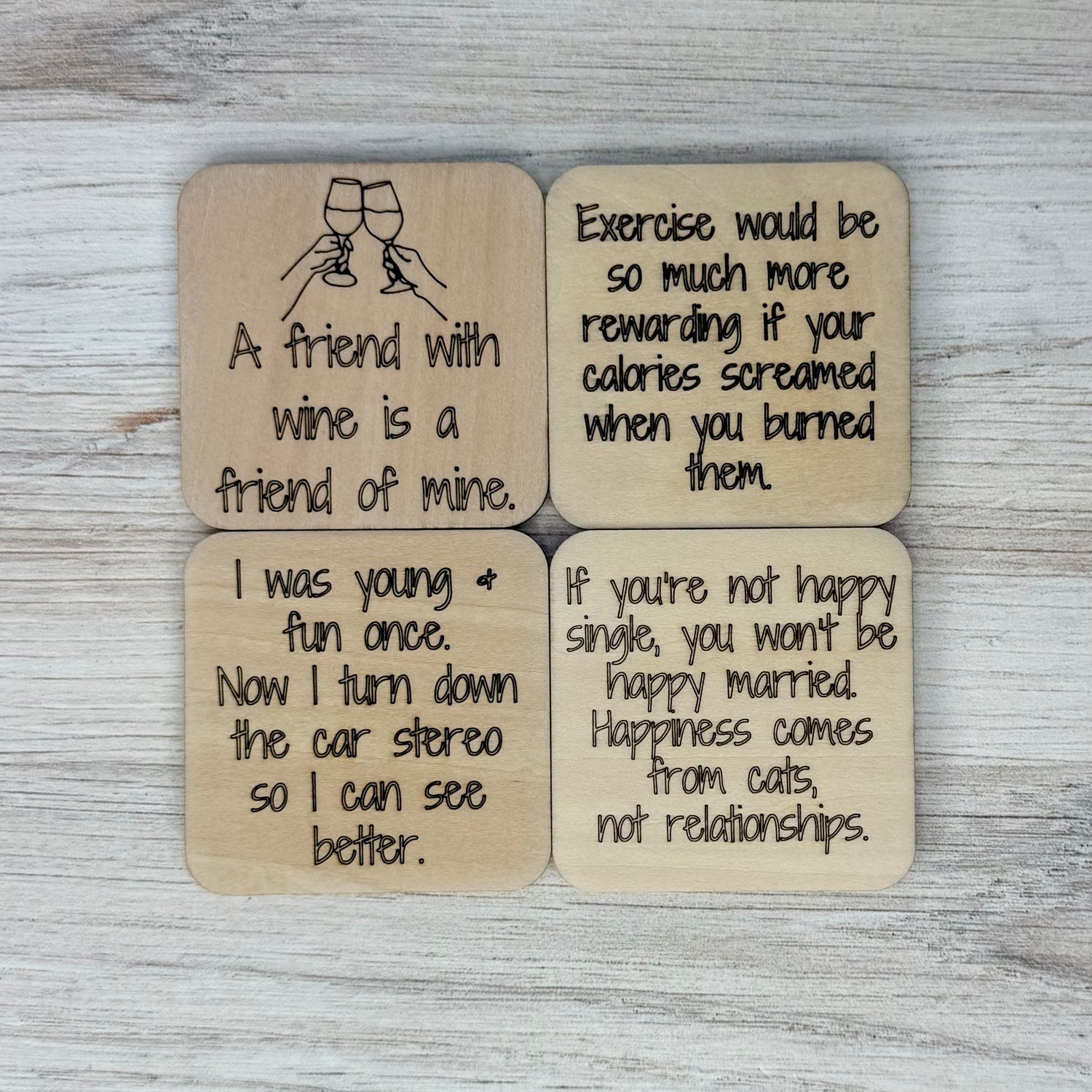 Laser-engraved wooden fridge magnets from Pineapples and Palm Trees, each featuring a different witty or heartwarming quote —  full of personality.