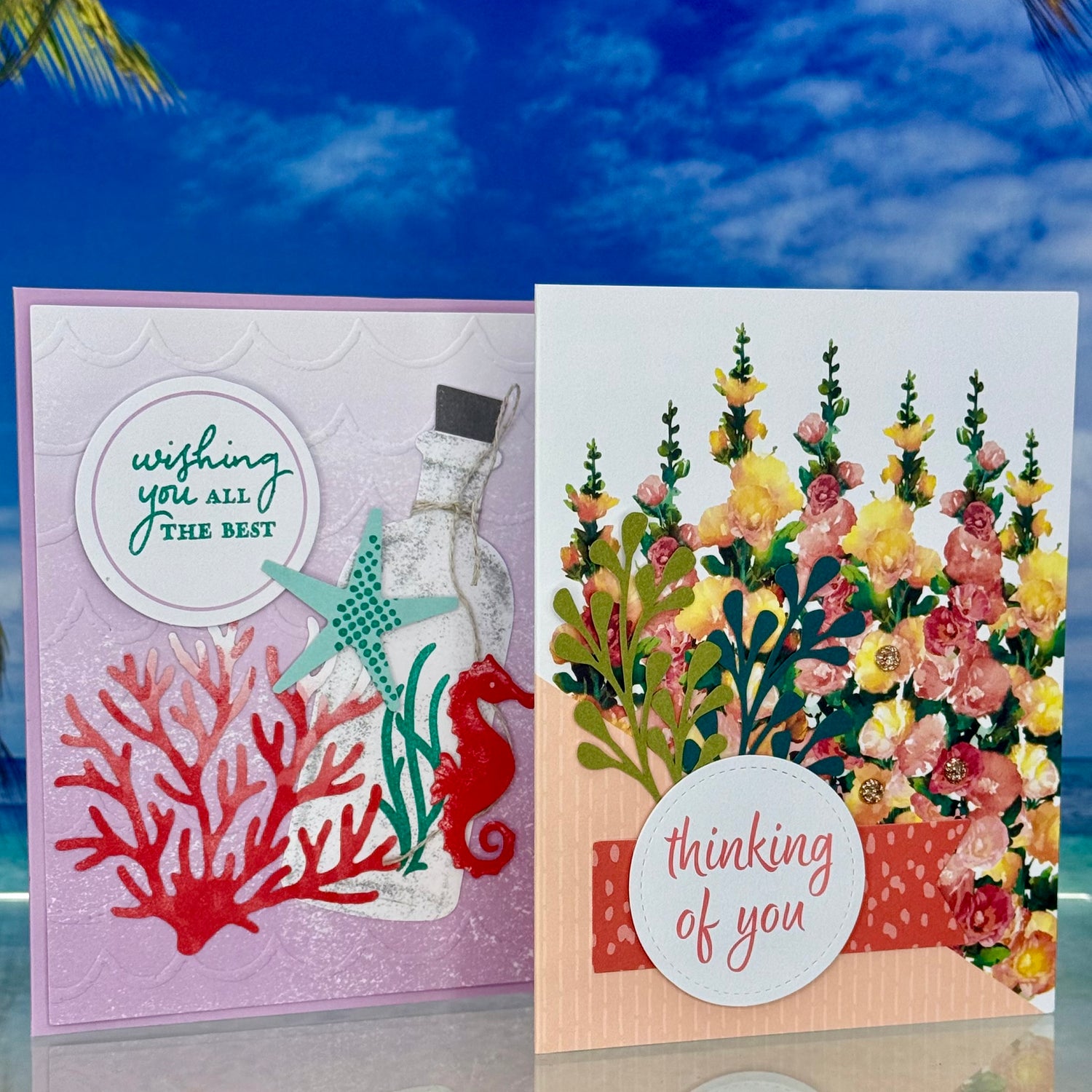 Two handcrafted greeting cards from Pineapples and Palm Trees — one reading ‘Wishing You All the Best’ and the other ‘Thinking of You,’ featuring delicate designs for thoughtful gifting.