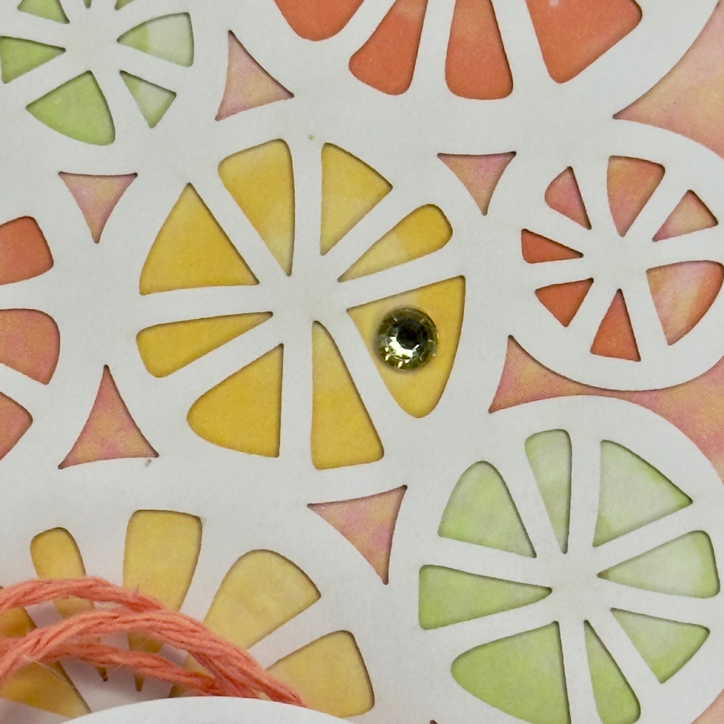 Handcrafted citrus detail on the greeting card with the message “May the good you do come back to you” on the front.