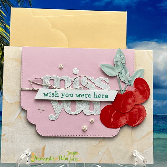 Handcrafted "Miss you, wish you were here" greeting card with pink background and red cherries on front.