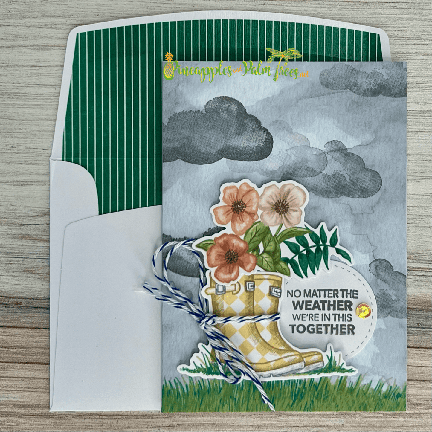 Handcrafted greeting card “No Matter the Weather We’re In This Together” with rain-boots design on front.