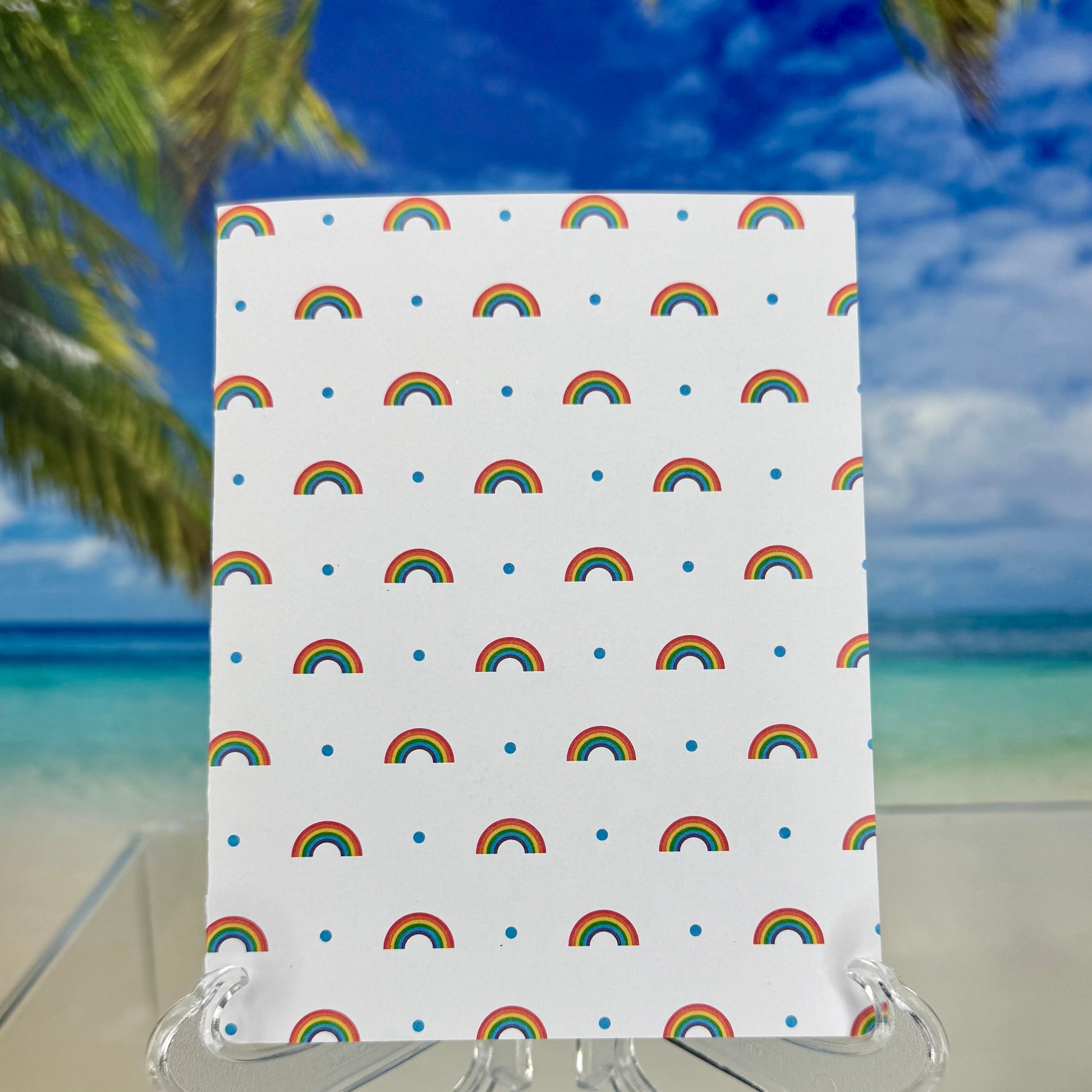 Back of “Rainbow Pattern & Clouds” greeting card showing plain cardstock back.