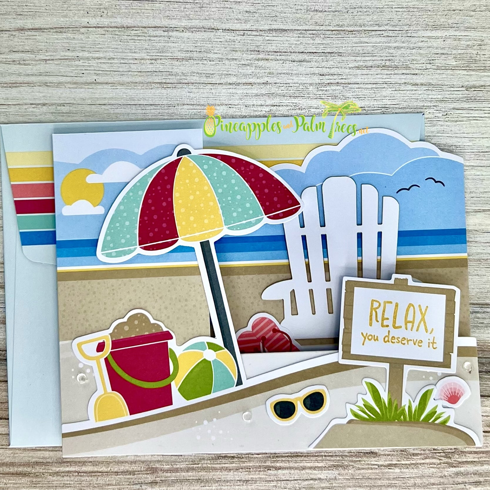 Greeting card “Relax – You Deserve It” featuring a beach scene illustration on the front.