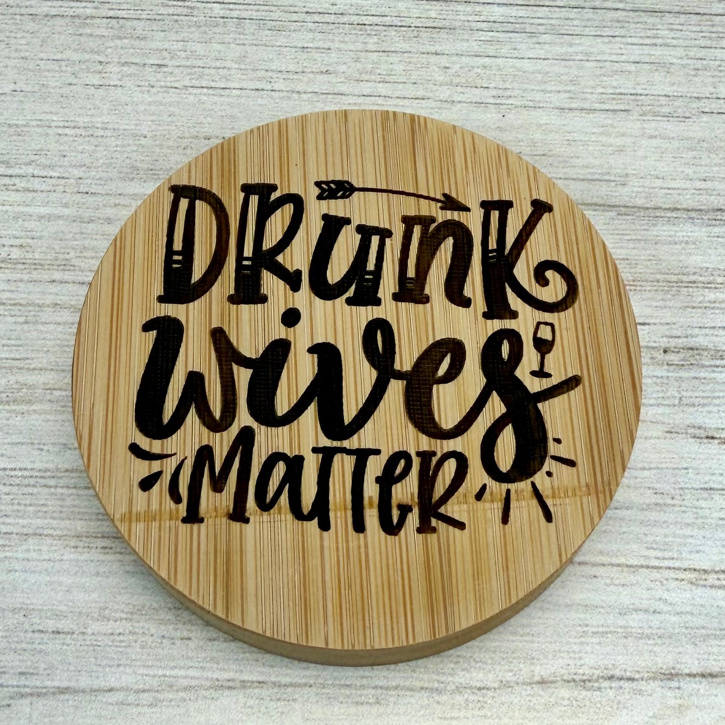 Round laser‑engraved bottle opener with humorous “Drunk Wives Matter” design, ideal for parties or gifts.