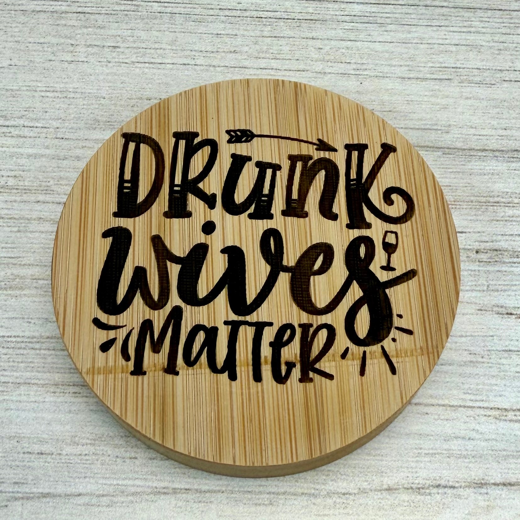 Round laser‑engraved bottle opener with humorous “Drunk Wives Matter” design, ideal for parties or gifts.