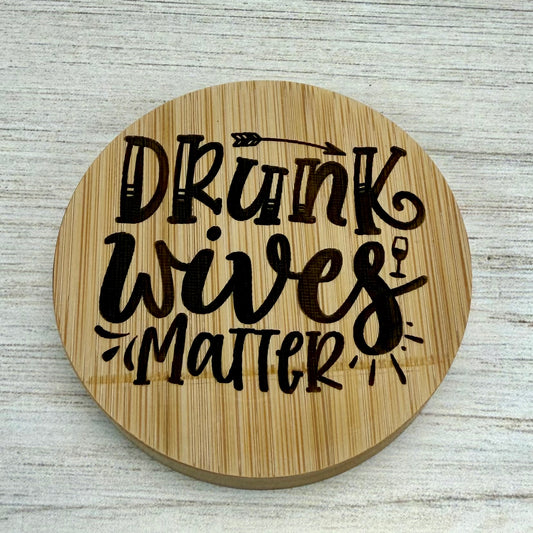 Round laser‑engraved bottle opener with humorous “Drunk Wives Matter” design, ideal for parties or gifts.