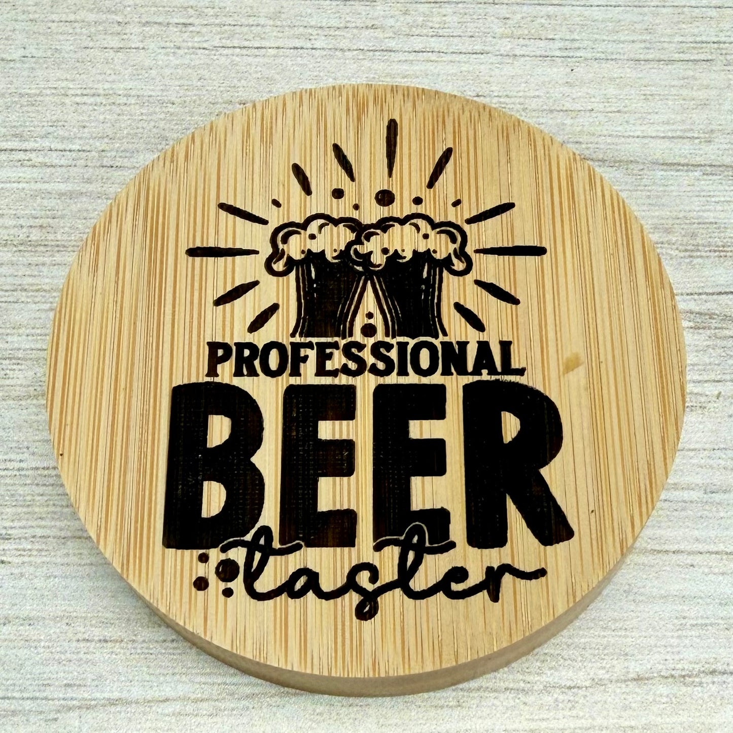 Round laser‑engraved bottle opener with “Professional Beer Taster” design, perfect for beer enthusiasts.