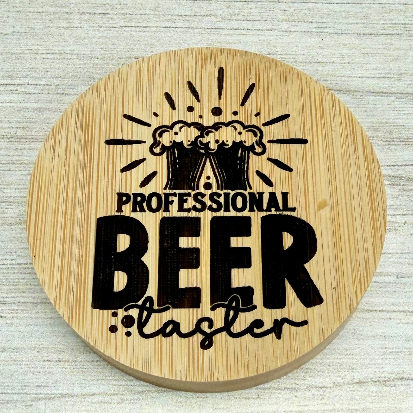 Round laser‑engraved bottle opener with “Professional Beer Taster” design, perfect for beer enthusiasts.