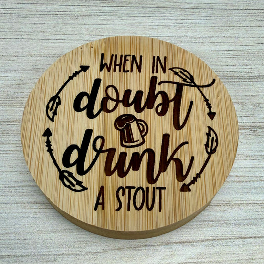 Round laser‑engraved bottle opener with “When in Doubt, Drink A Stout” design, ideal for beer lovers.