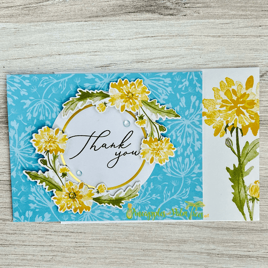Thank you greeting card decorated with dandelion seed-head illustration on front cover.