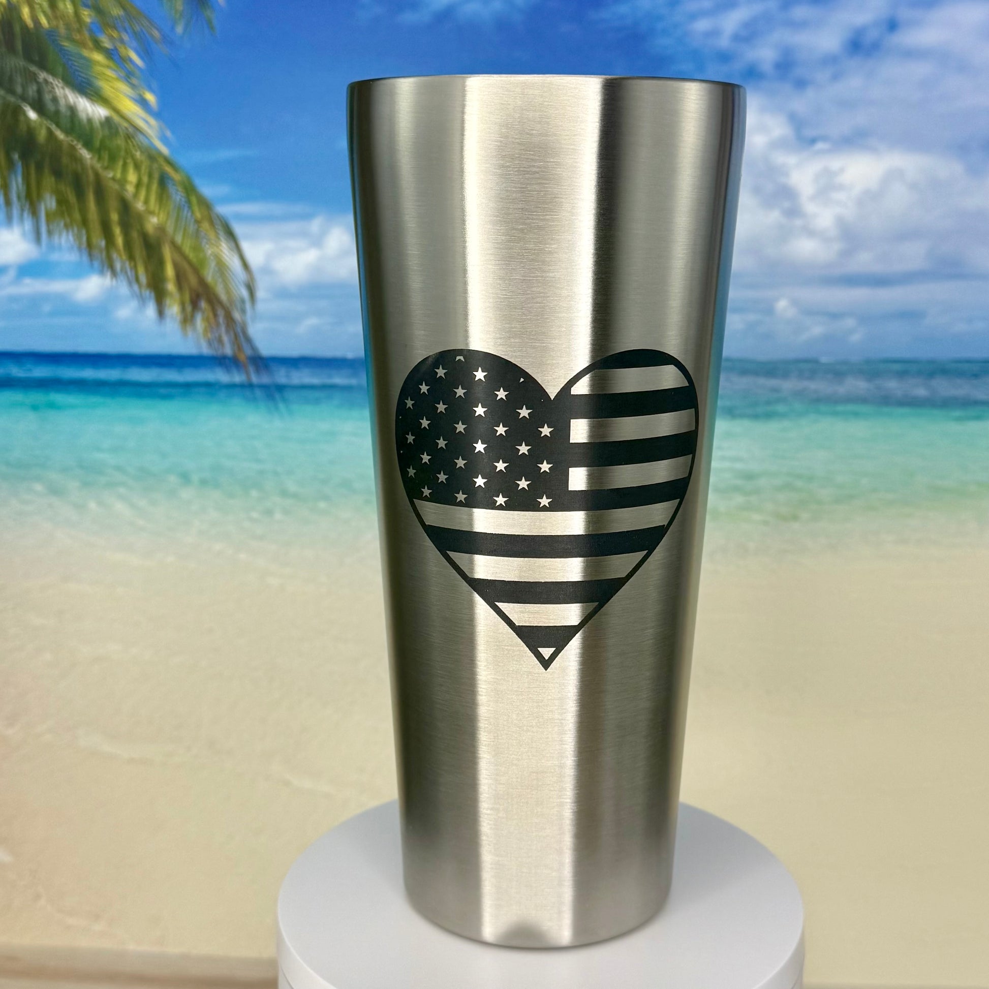 Stainless steel tumbler featuring America’s flag in a heart design, perfect for patriotic drinkware.