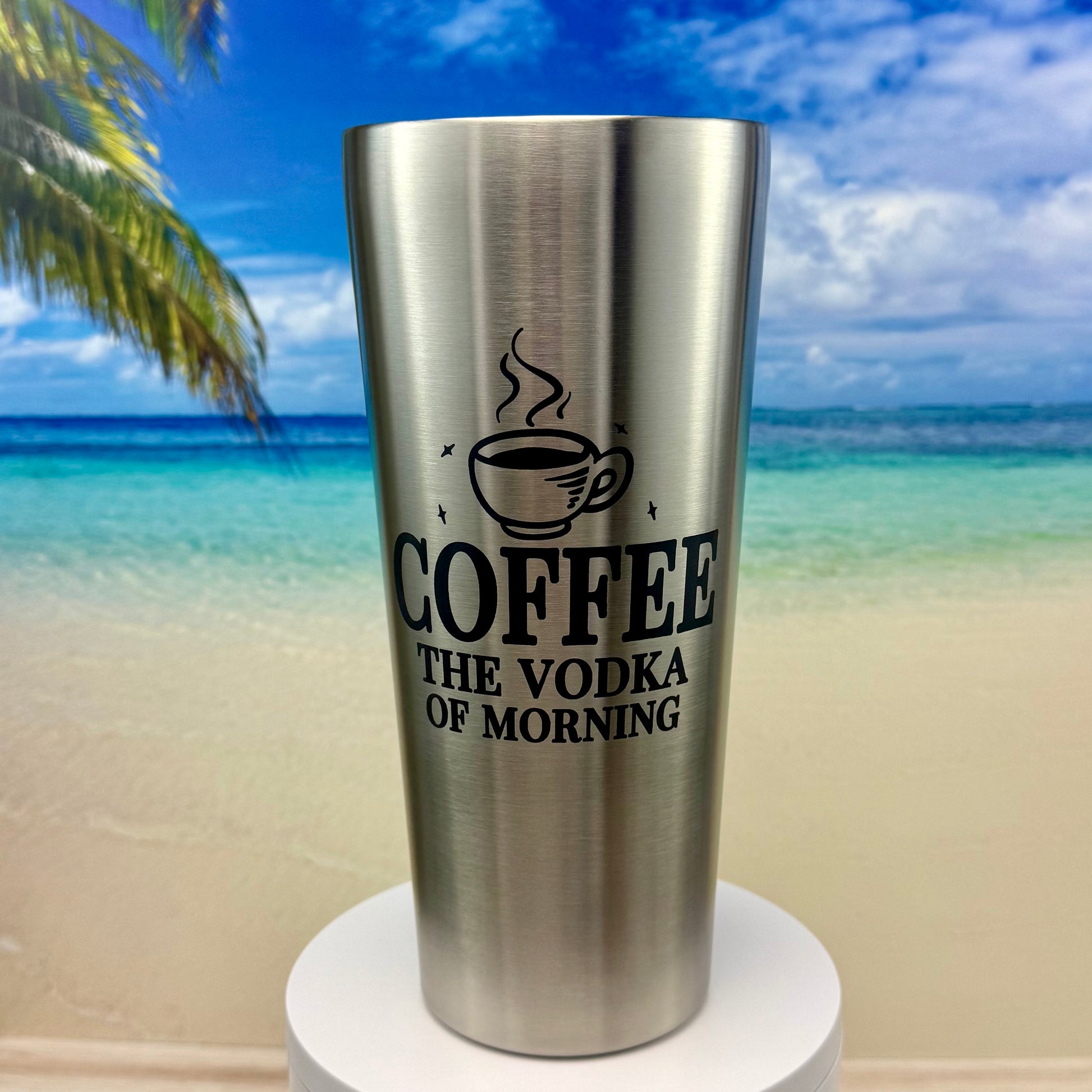 Stainless steel tumbler with “Coffee: The Vodka of Morning” humorous design on the front.
