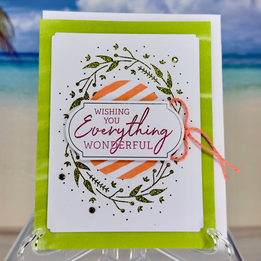 Greeting card “Wishing You Everything Wonderful” with a decorative wreath illustration on the front cover.