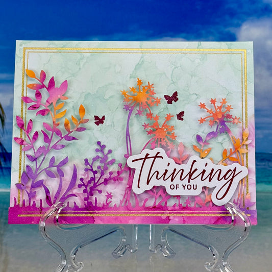Greeting card “Thinking of You” with colorful floral bouquet illustration on front cover.