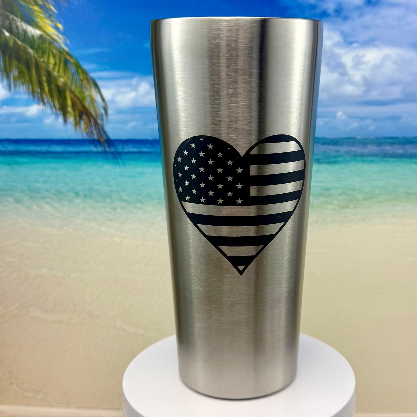 Stainless steel tumbler featuring America’s flag in a heart design, perfect for patriotic drinkware.