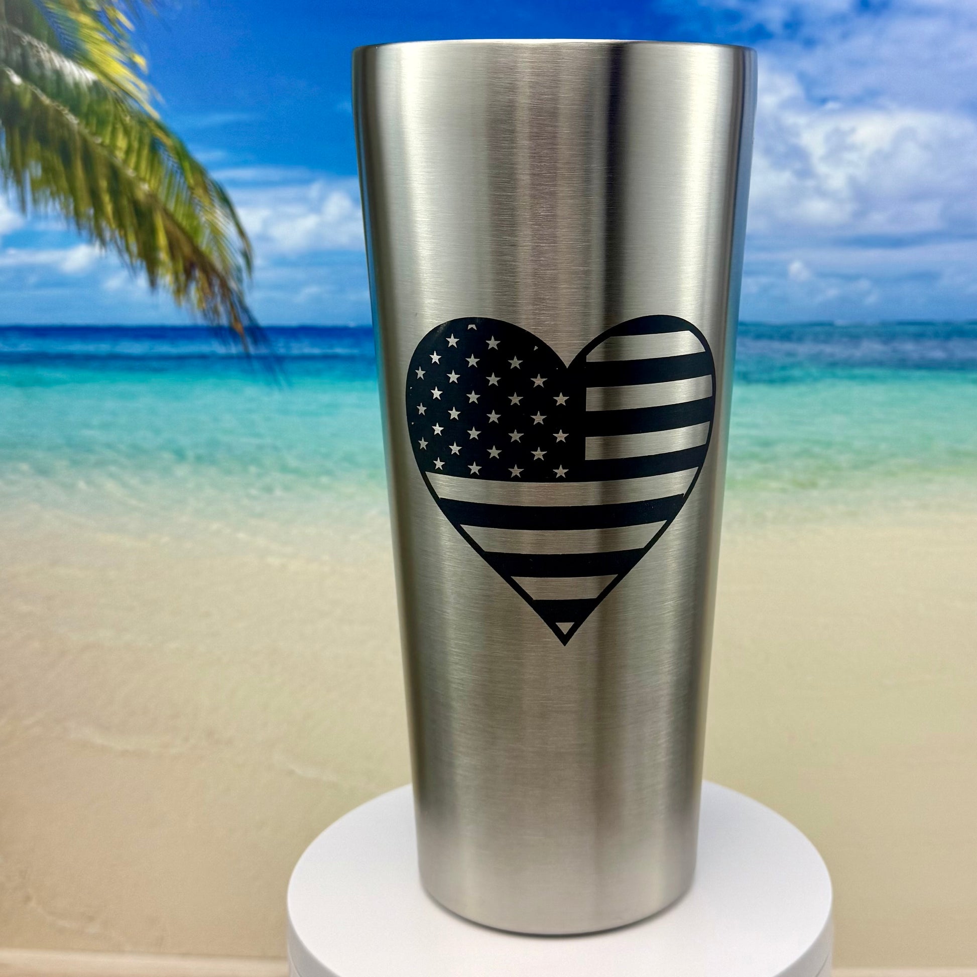 Stainless steel tumbler featuring America’s flag in a heart design, perfect for patriotic drinkware.