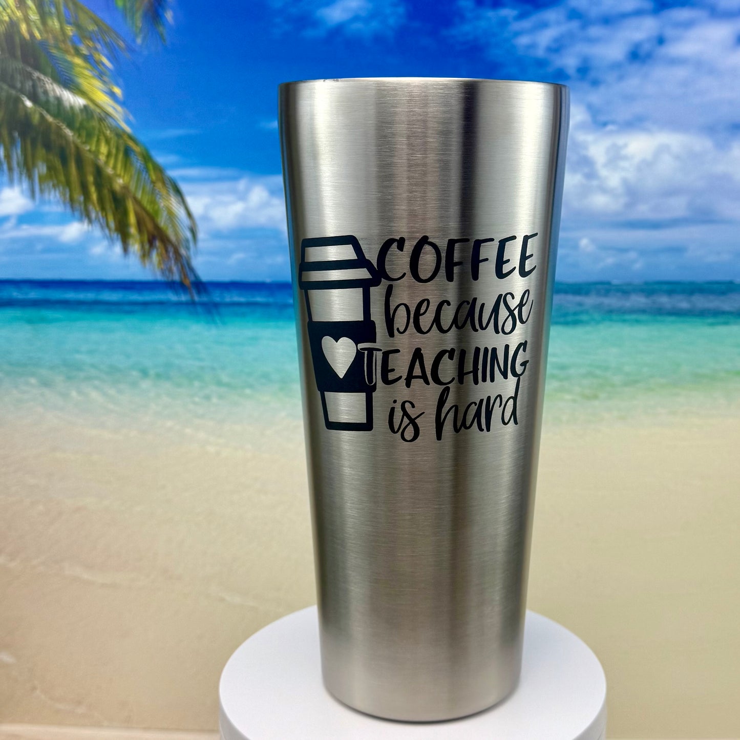Stainless steel tumbler with “Coffee Because Teaching Is Hard” coffee‑themed design on the front.