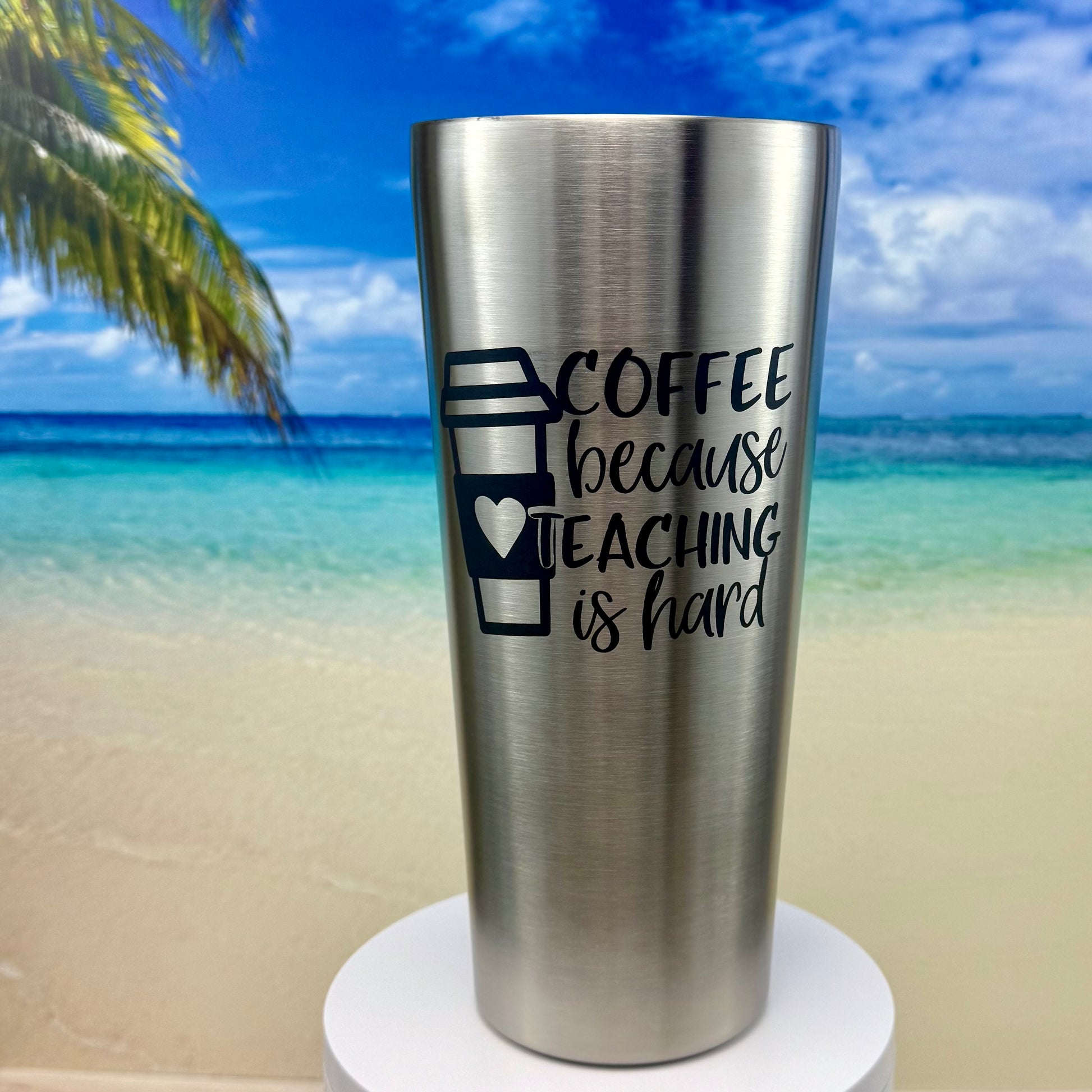 Stainless steel tumbler with “Coffee Because Teaching Is Hard” coffee‑themed design on the front.