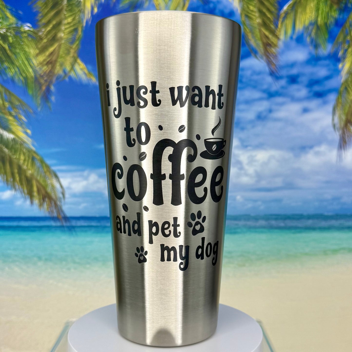 Stainless steel tumbler with “I Just Want to Coffee and Pet My Dog” design on the front.