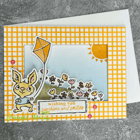 Greeting card “Wishing You Sunshine and Smiles” featuring a playful bunny flying a kite illustration on the front.