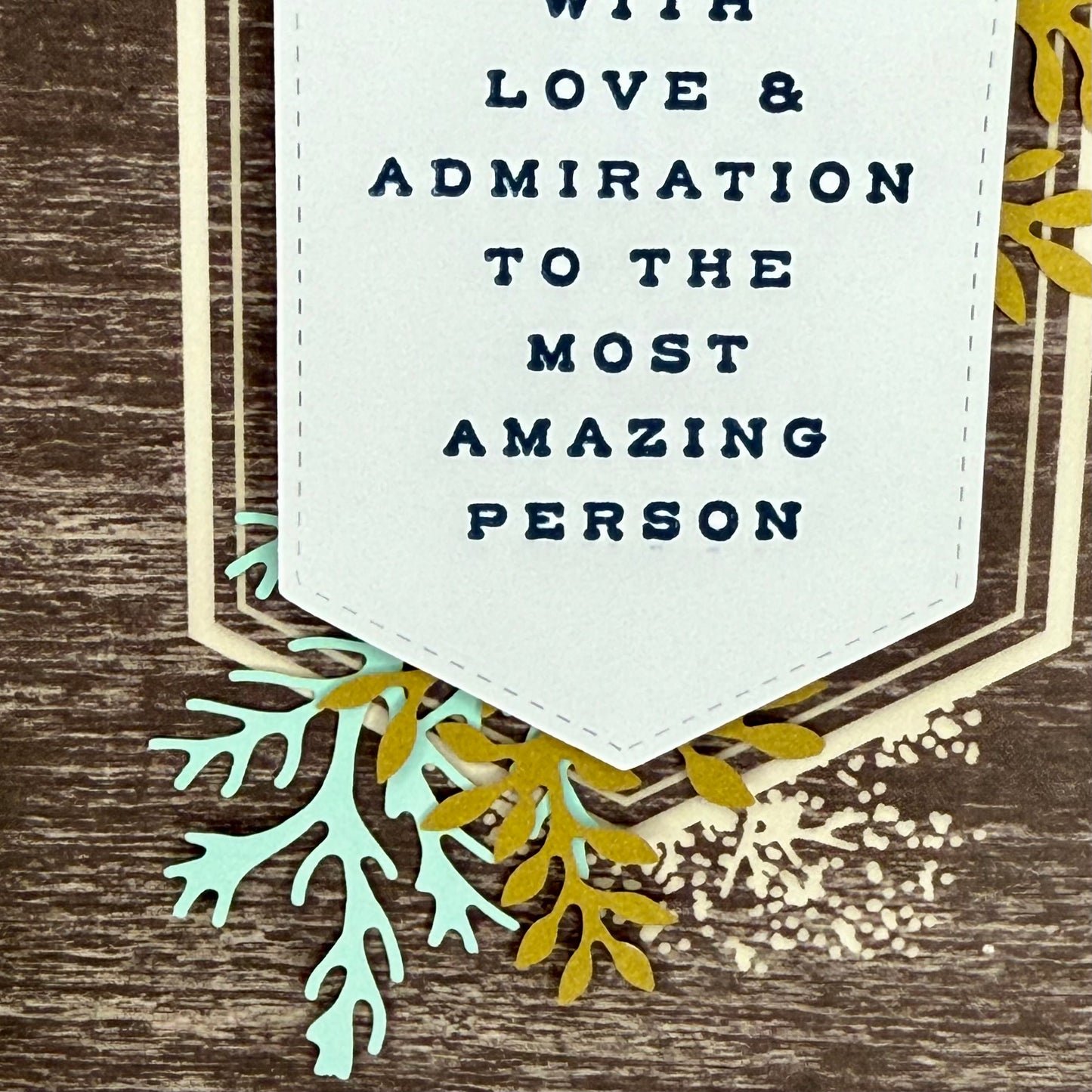 Details of greeting card with the message ‘With love and admiration to the most amazing person,’ featuring elegant tree designs.