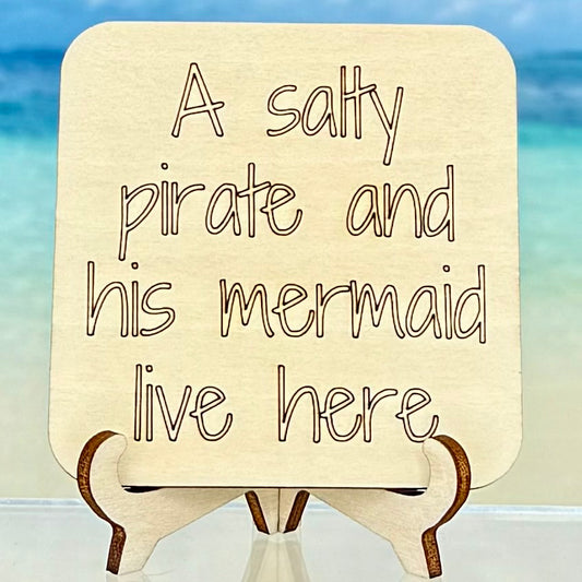 Laser-cut wooden fridge magnet engraved with the phrase ‘A Salty Pirate and His Mermaid Live Here’ — handcrafted coastal-themed décor with a strong magnet backing, perfect for beach homes or gift giving.