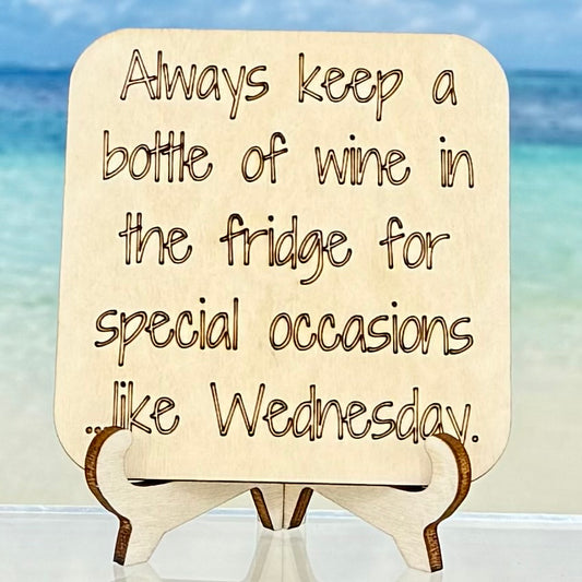 Laser-cut wooden fridge magnet engraved with the quote ‘Always keep a bottle of wine in the fridge for special occasions… like Wednesday.’ — humorous décor piece for wine lovers.