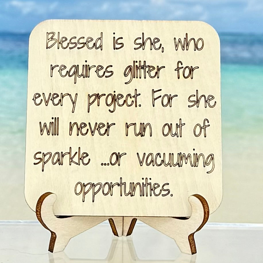 Laser-cut wooden fridge magnet engraved with the quote ‘Blessed is she, who requires glitter for every project, for she shall never run out of sparkle…or vacuuming opportunities.’ — handcrafted with strong magnet backing, perfect gift for crafty souls.