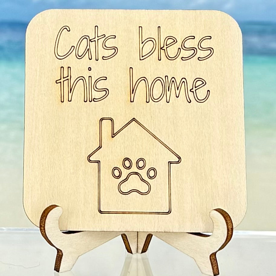 Laser-cut wooden fridge magnet engraved with the quote ‘Cats Bless This Home’ and a paw print symbol — handcrafted décor gift for cat lovers.