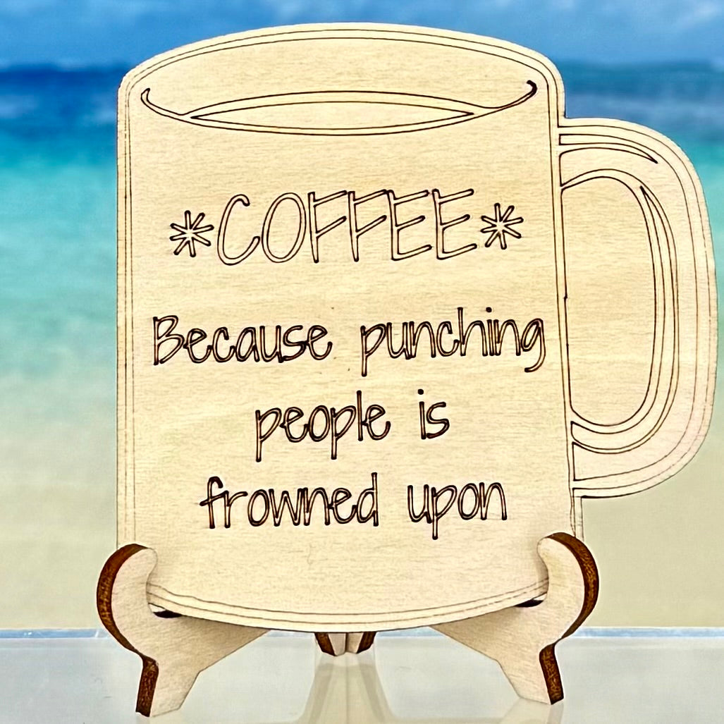 Laser-cut wooden fridge magnet engraved with the quote ‘Coffee — because punching people is frowned upon’ — handcrafted, humor-filled décor piece perfect for the kitchen or office.”
